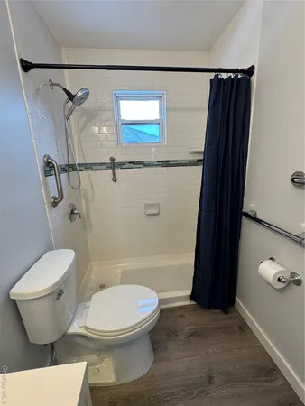a bathroom with a bathtub and a toilet