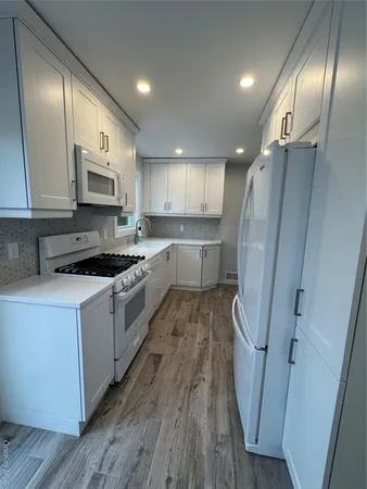a white refrigerator freezer sitting inside of a kitchen