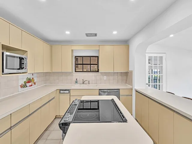 a kitchen that has a sink and a stove in it