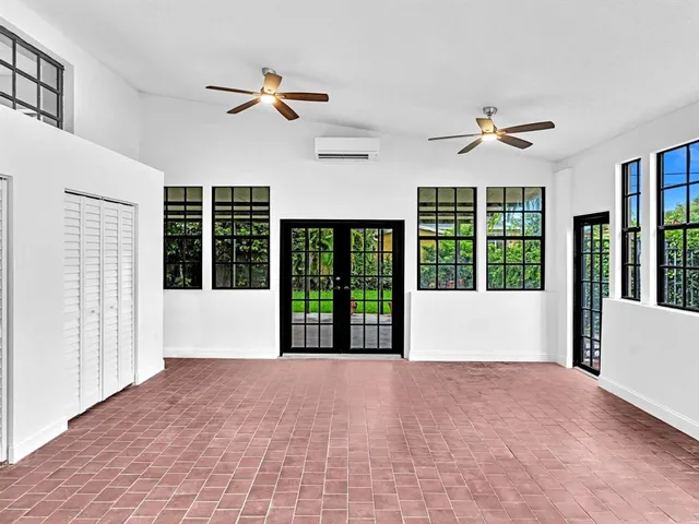 a view of a livingroom with wooden floor and a ceiling fan