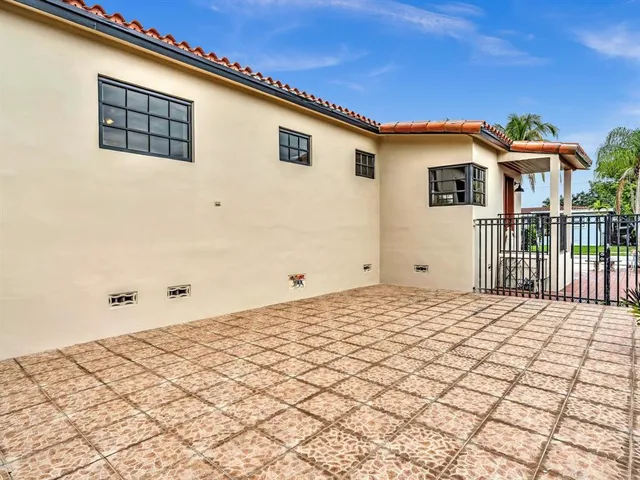 a front view of a house with backyard and sitting area