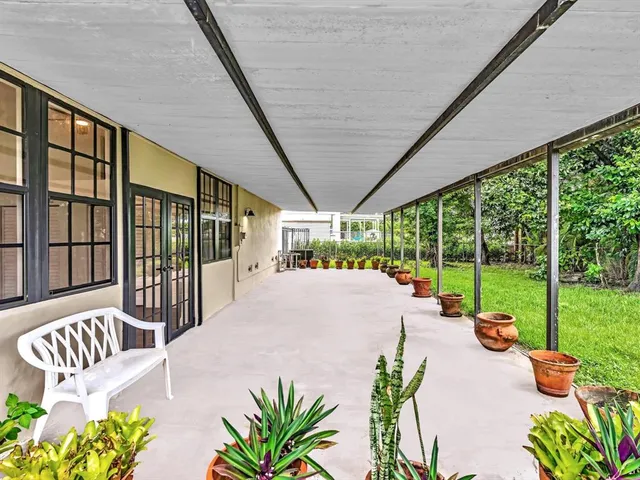 a view of an empty room with window and cabinet