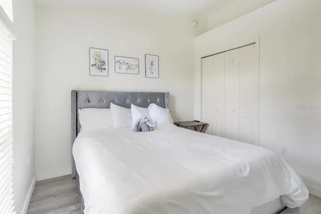 a large bed sitting in a bedroom next to a window