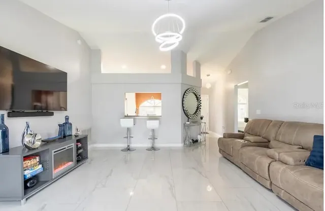 a living room with fireplace furniture and a flat screen tv