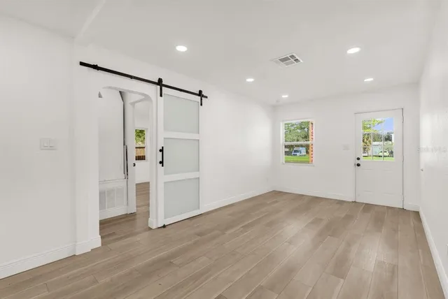 wooden floor in an empty room with a window