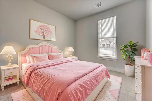 a bedroom with bed and a potted plant