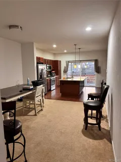 a living room with furniture and a piano
