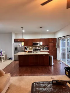 a large kitchen with kitchen island a sink stainless steel appliances and cabinets