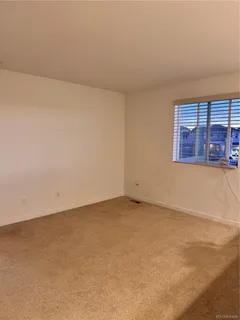 an empty room with a empty space and windows