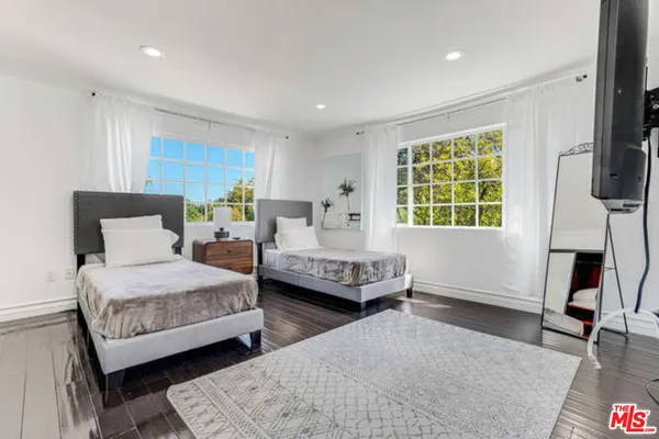 a bedroom with furniture and a window
