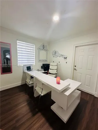 a living room with patio furniture and a washing machine in a center