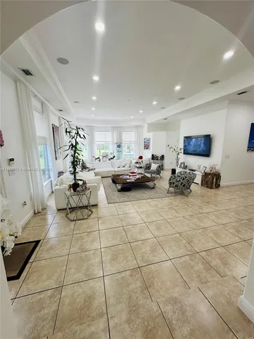 a view of a livingroom with furniture and a gym equipment