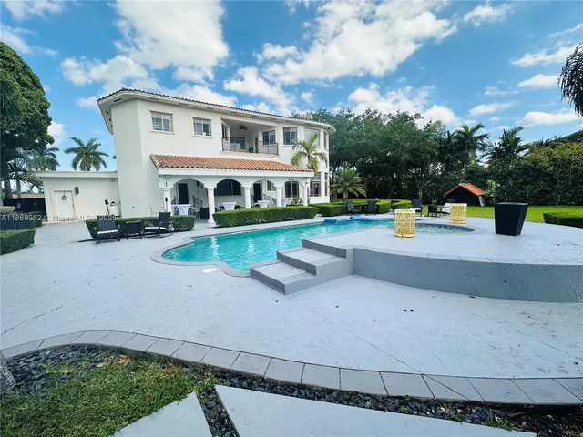 a outdoor space with patio furniture and a fireplace