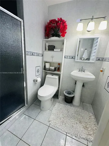 a bathroom with a sink toilet and a mirror