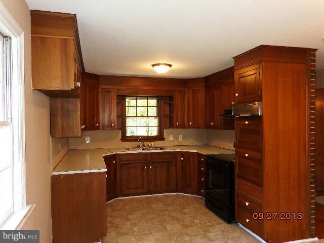 13126 Draper Road Clear Spring, MD 21722 - Photo 13 of 30 a kitchen with granite countertop a sink cabinets and a window