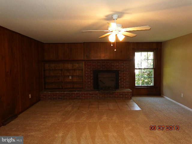 13126 Draper Road Clear Spring, MD 21722 - Photo 15 of 30 a view of an empty room with a fireplace and a window