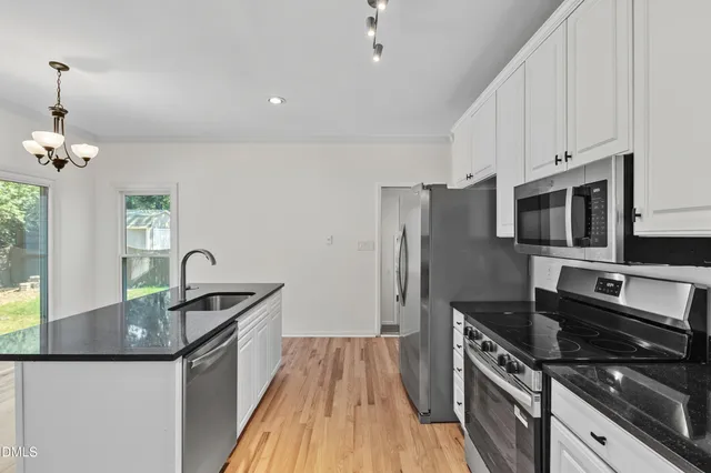 a view of room with hardwood floor and cabinet