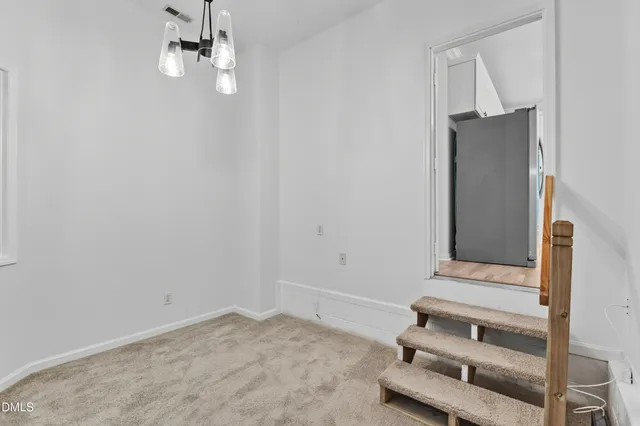 a living room with furniture and a book shelf