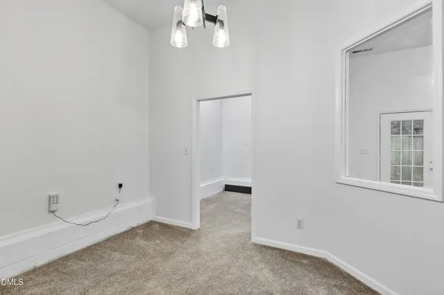an empty room with closet and mirror