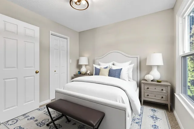 a spacious bedroom with a bed and large windows