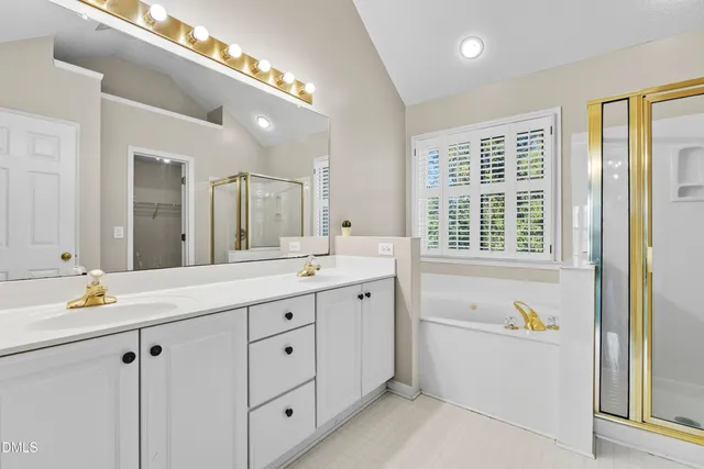 a bathroom with a double vanity sink mirror and
