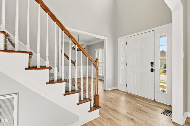 a living room with furniture flowers and a window