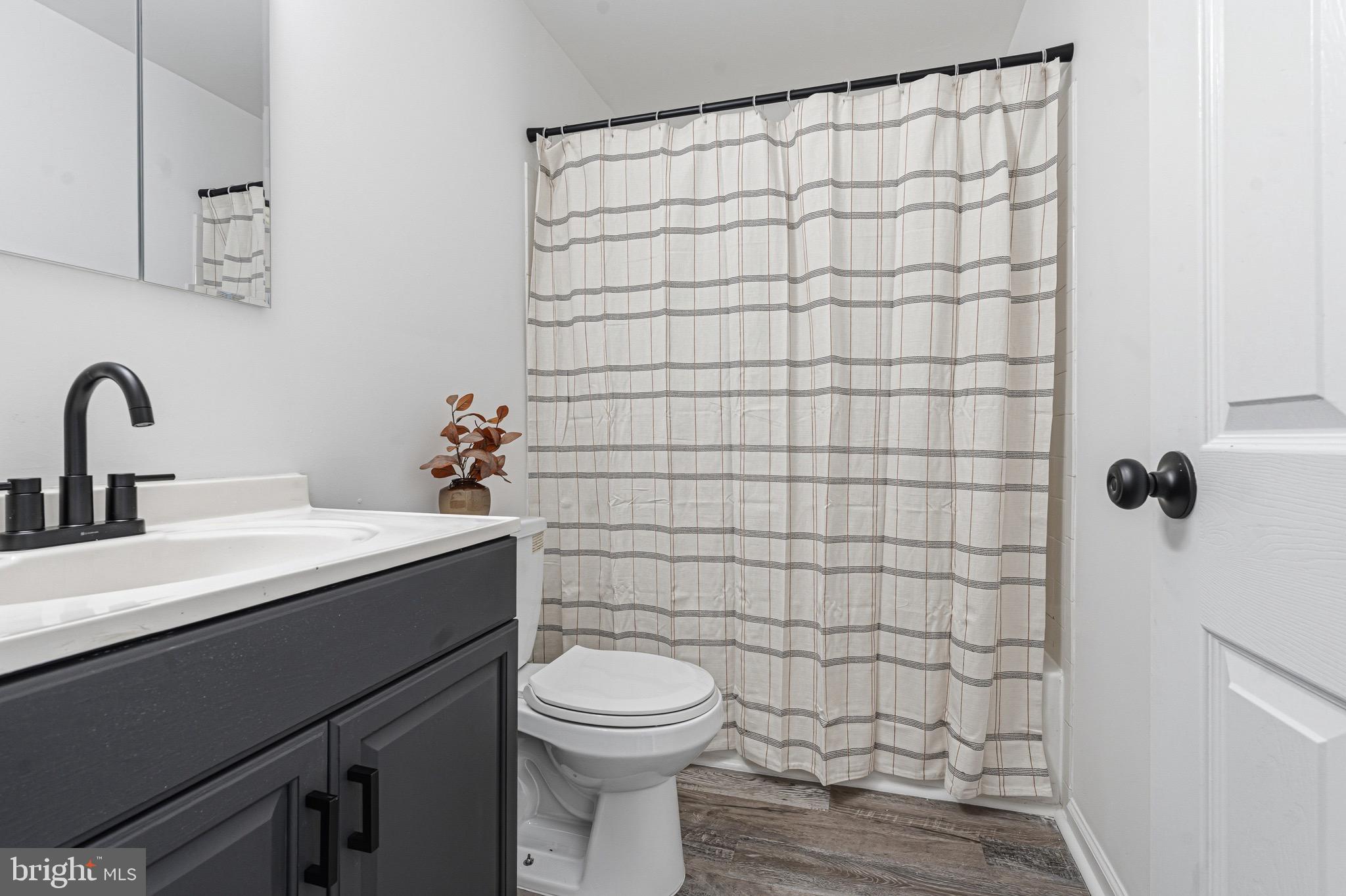 8110 North Boundary Road Dundalk, MD 21222 - Photo 11 of 24 a bathroom with a sink a toilet and shower