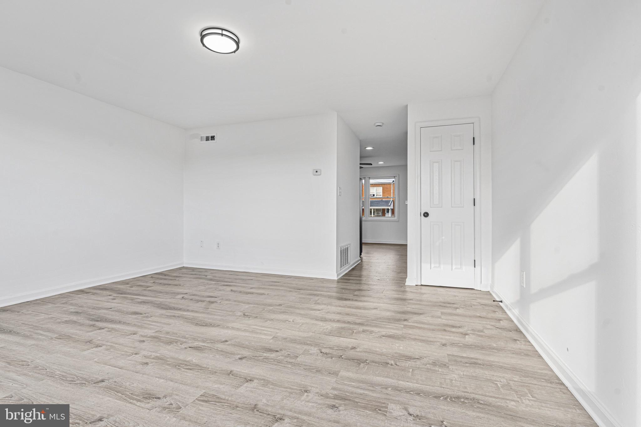 8110 North Boundary Road Dundalk, MD 21222 - Photo 3 of 24 a view of an empty room with wooden floor