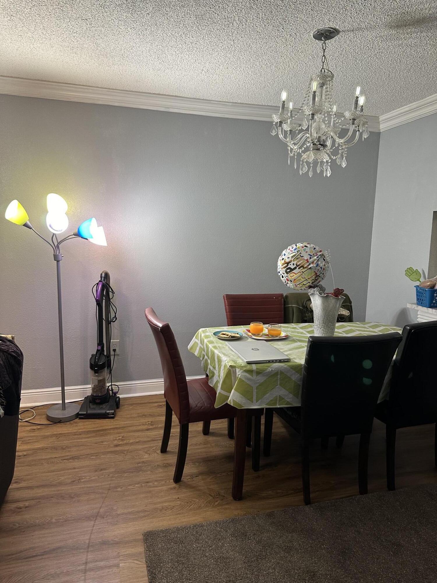 8341 Sands Point Boulevard, Unit B206 Tamarac, FL 33321 - Photo 2 of 11 a view of a dining room with furniture and wooden floor
