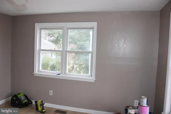 a room with a window and a chandelier