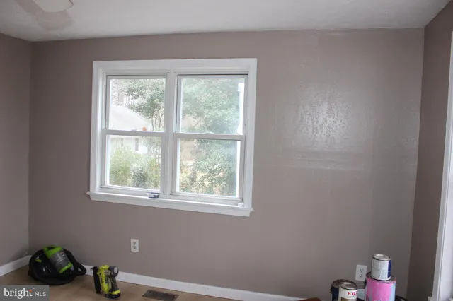 a room with a window and a chandelier