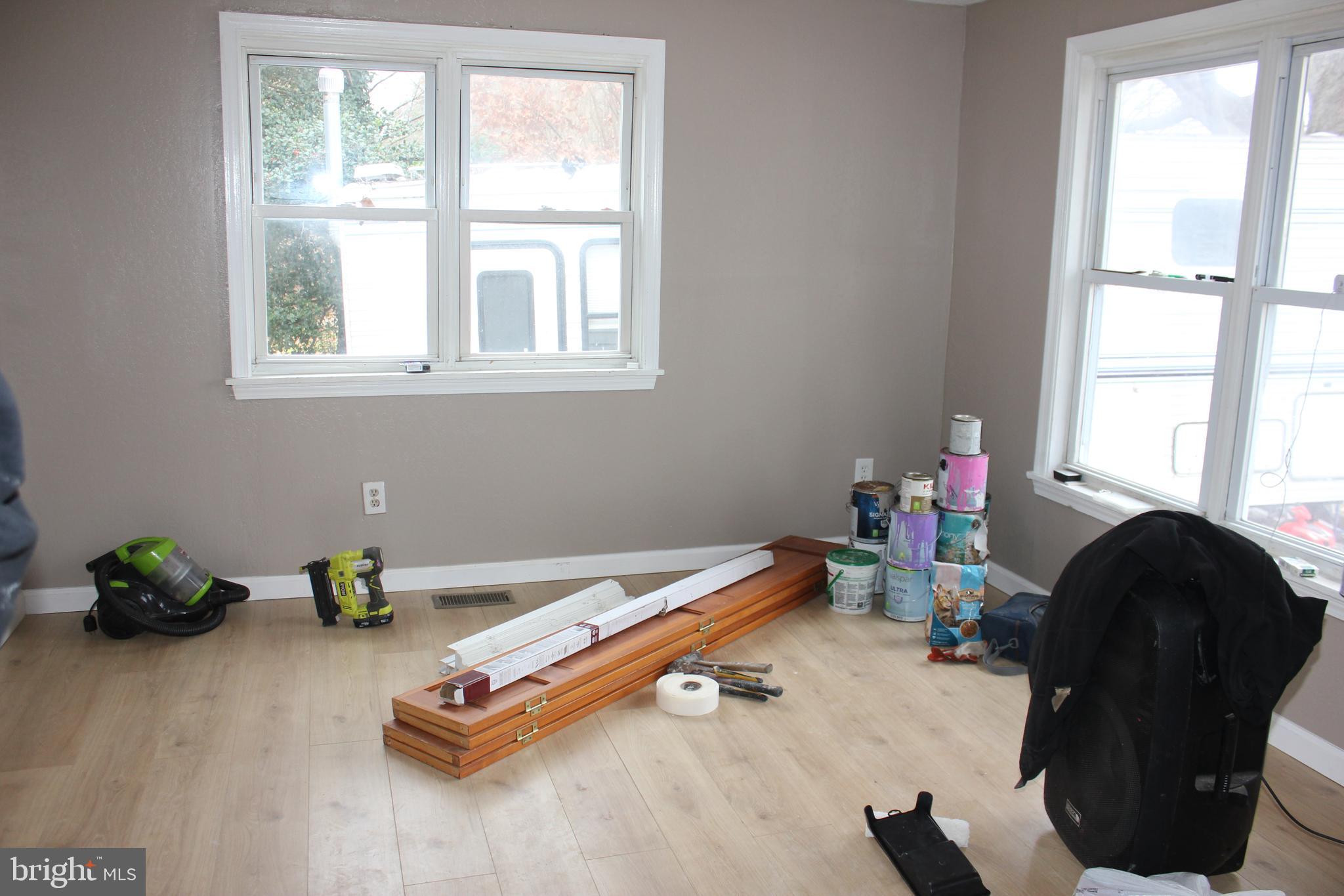 48907 Chisleytown Road St. Inigoes, MD 20684 - Photo 4 of 8 a room with a window and a chandelier