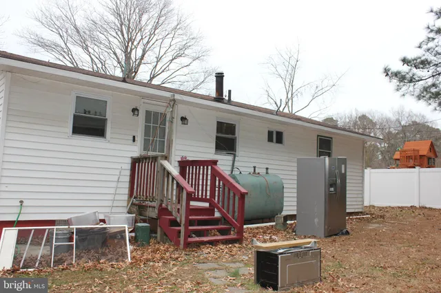 a backyard of a house with table and chairs