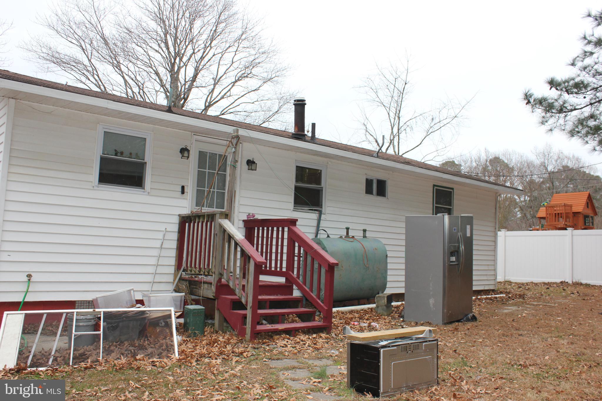 48907 Chisleytown Road St. Inigoes, MD 20684 - Photo 6 of 8 a view of a patio with a yard