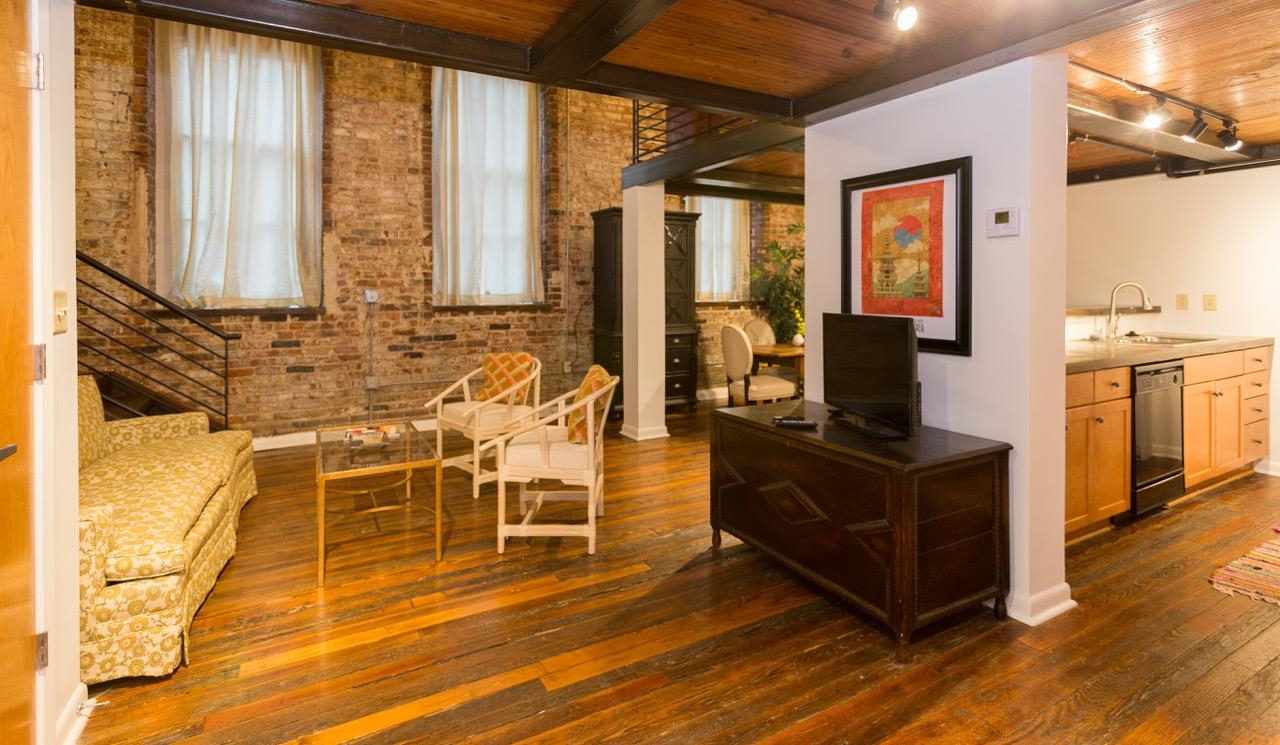 50 Gayoso Avenue, Unit 306 Memphis, TN 38103 - Photo 13 of 25 a living room with furniture windows and wooden floor
