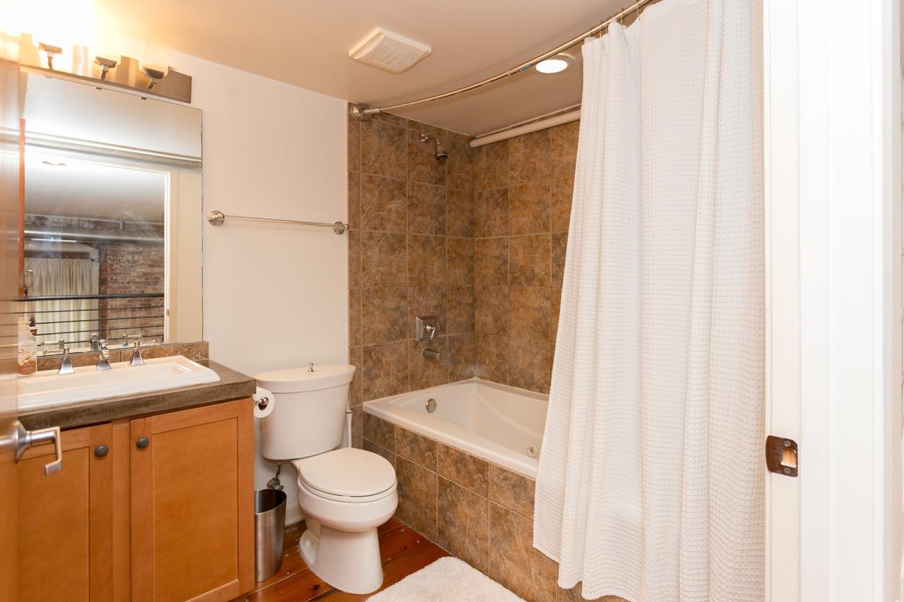 50 Gayoso Avenue, Unit 306 Memphis, TN 38103 - Photo 22 of 25 a bathroom with a sink toilet and shower