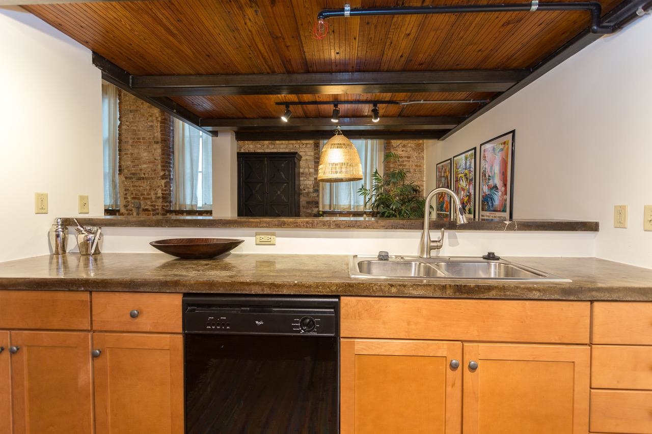 50 Gayoso Avenue, Unit 306 Memphis, TN 38103 - Photo 8 of 25 a kitchen with a sink and cabinets
