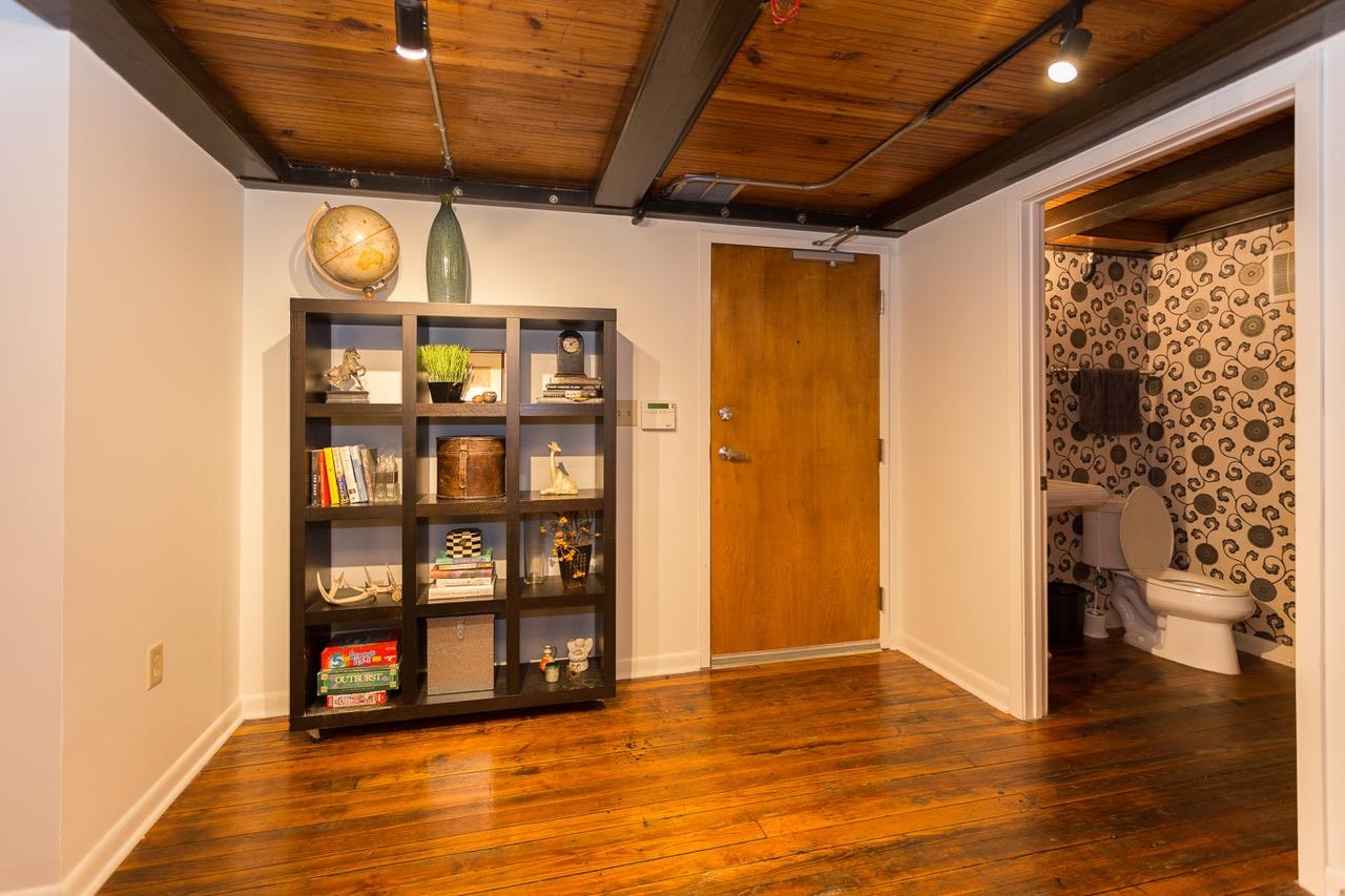 50 Gayoso Avenue, Unit 306 Memphis, TN 38103 - Photo 9 of 25 a view of an empty room with wooden floor and a window