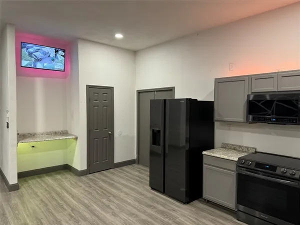 a kitchen with a refrigerator and a stove
