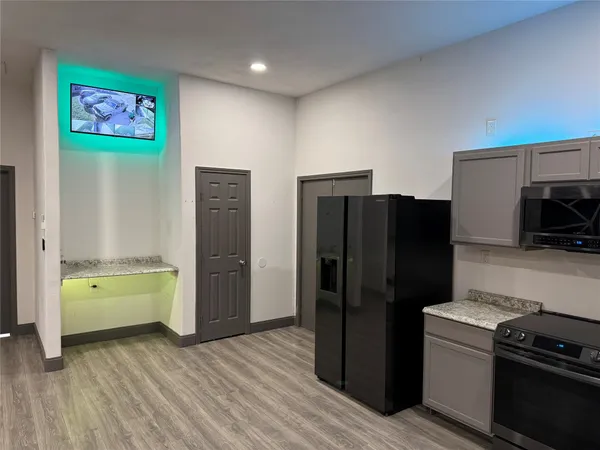a kitchen with a refrigerator and a stove