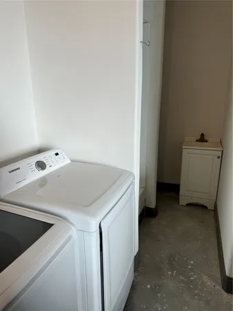 a white toilet sitting next to a bathroom sink