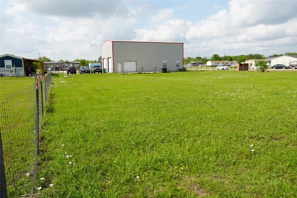 a view of a big yard with a building in the background