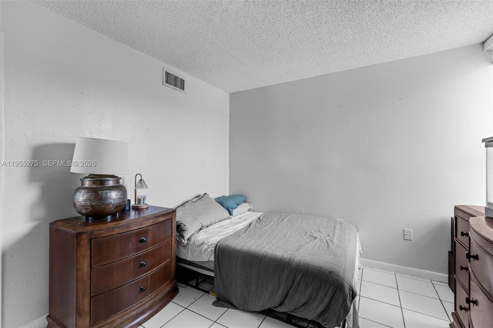 20033 Southwest 123rd Drive Miami, FL 33177 - Photo 13 of 22 a bedroom with a bed and cabinets