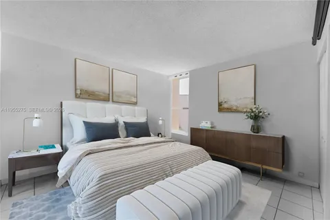 a bedroom with a bed and a potted plant