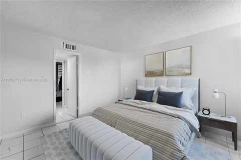 a bedroom with a bed and a painting on the wall