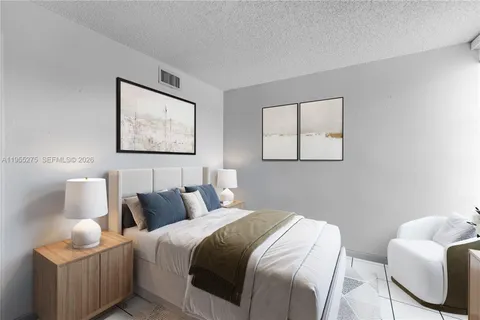 a bedroom with a bed and chair