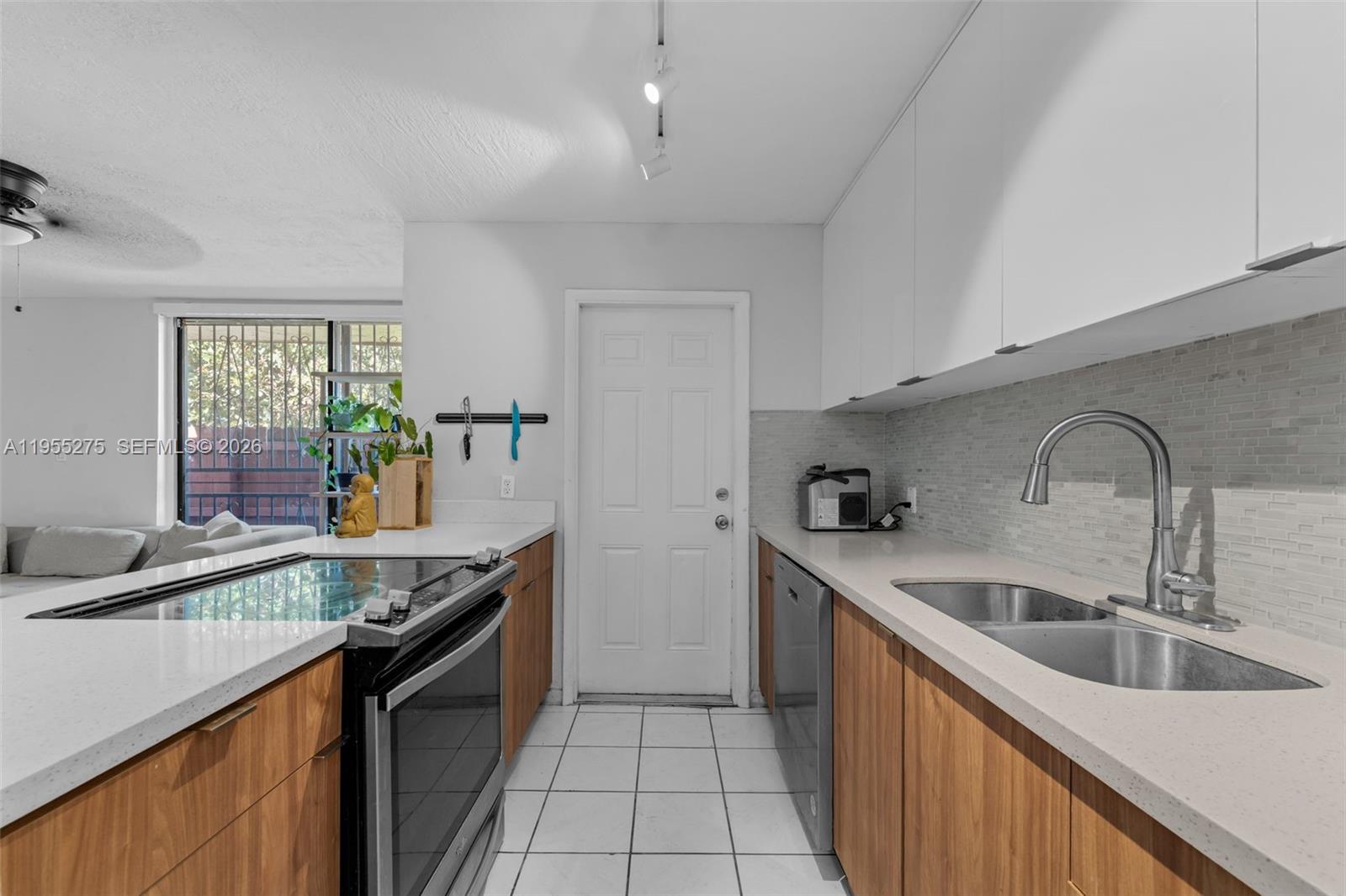 20033 Southwest 123rd Drive Miami, FL 33177 - Photo 3 of 22 a kitchen with stainless steel appliances granite countertop a sink and a stove