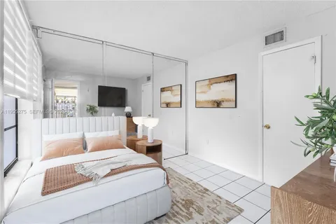 a bedroom with a large bed and a couch