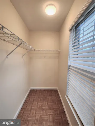 an empty room with a flat screen tv and a window