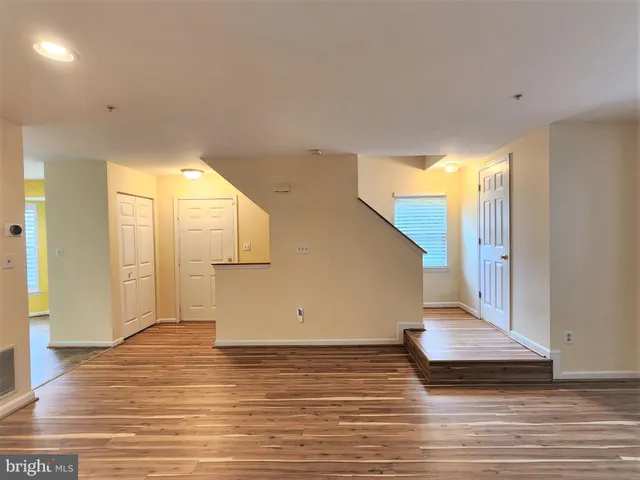 a view of a room with wooden floor and staircase